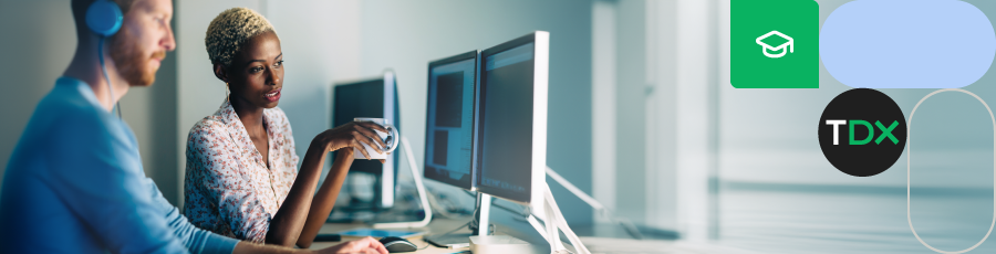 he is sitting with his earphones and she's looking into his computer while reading about CISA Training