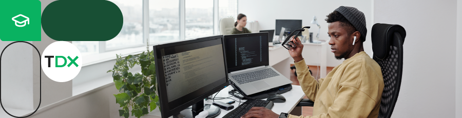 Person working at a desk with multiple monitors, representing CISA Certification