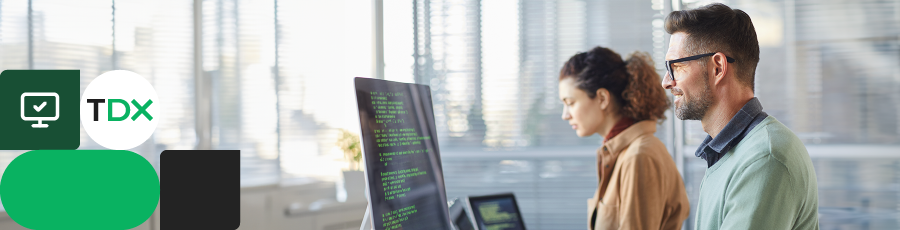 Two people looking at a computer screen with code, representing CISSP.