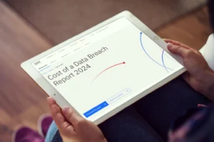 Tablet showing ‘Cost of a Data Breach Report 2024’ with graphs on cybersecurity attack impacts